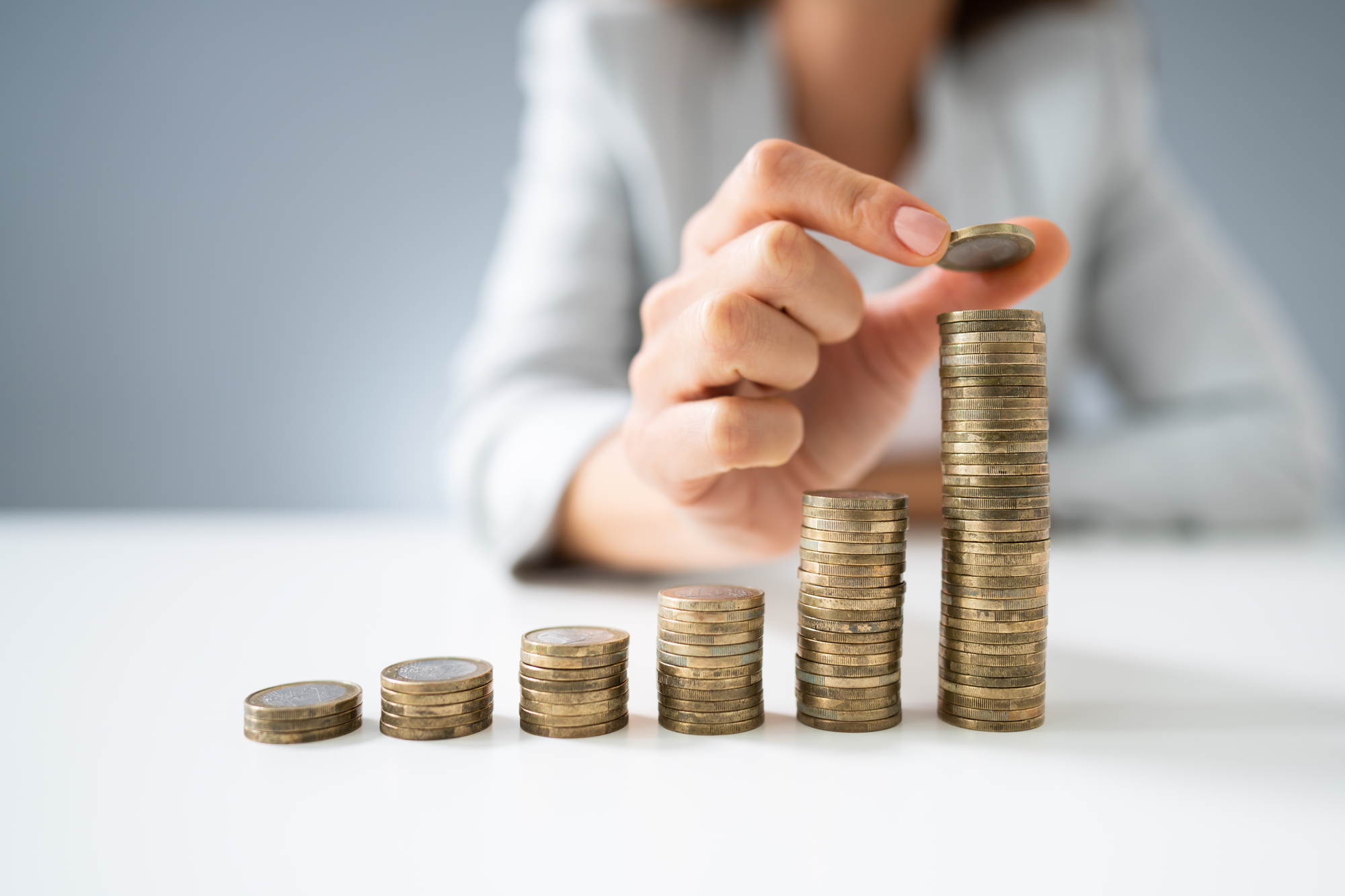 Busineasswoman Hand Put Coins To Stack Of Coins